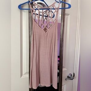 Pale pink tank top with strappy design on chest and back